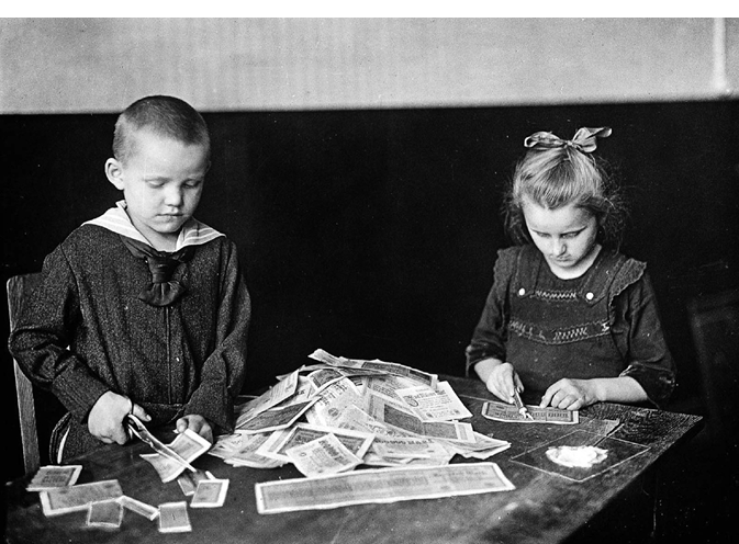 Children play with worthless bank notes
