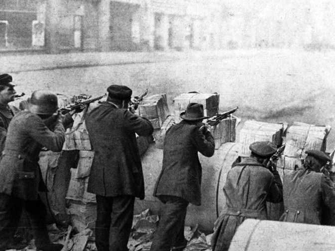 Spartacists behind a barricade made out of newspapers during the uprising